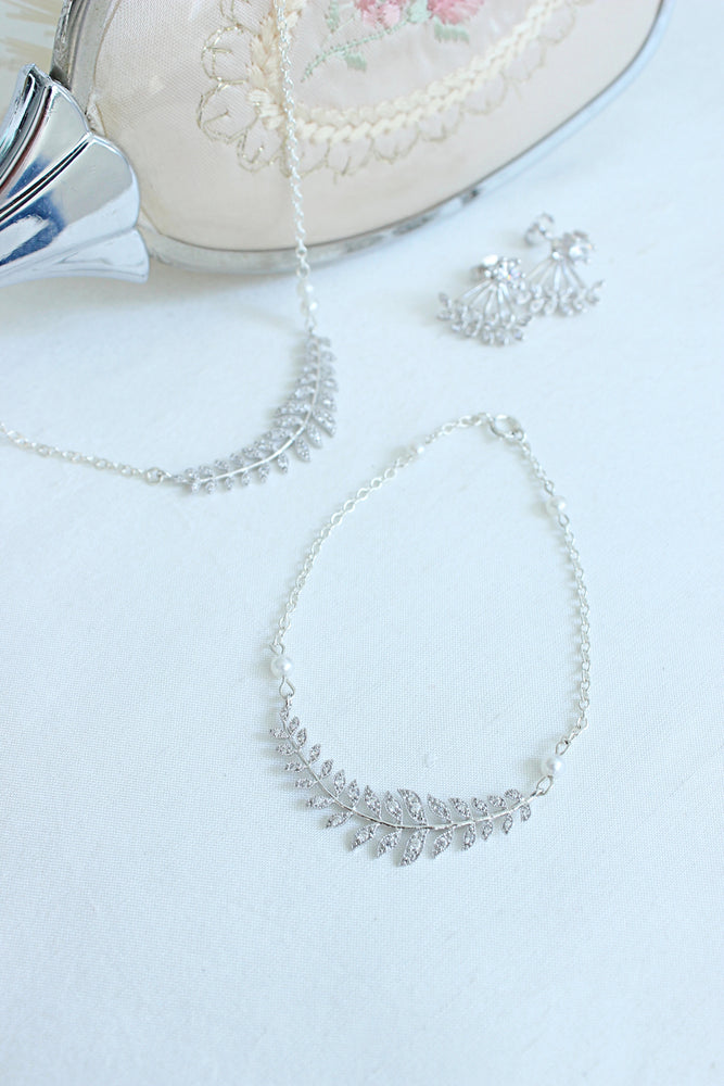 silver leaf bridal necklace and bracelet, bridal necklace and bracelet with leaf details and pearls, pearl bridal necklace and bracelet, custom made wedding necklace, dainty and simple bridal wedding necklace, bridal ear cuffs, bridal earrings, bridal lea