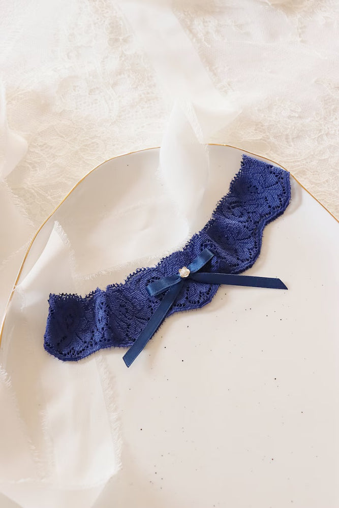 Single scalloped navy blue lace wedding garter with bow and silver flower