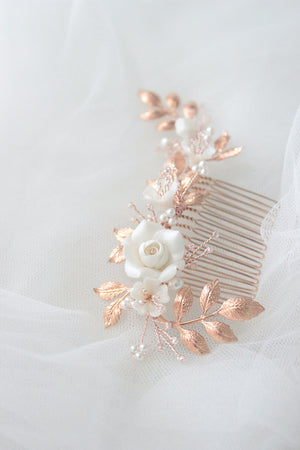 rose gold wedding hair piece for bride featuring clay flowers and crystals that can be worn on the side and with a veil