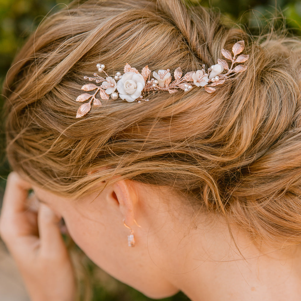 Romantic and modern  bridal updo hairstyle with rose gold hair piece
