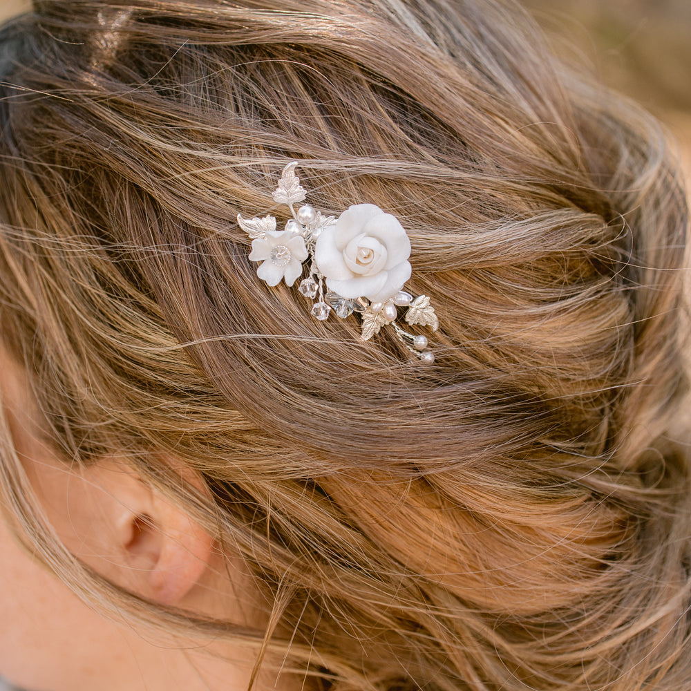 petite and dainty bridal hair comb with floral details and blue crystals