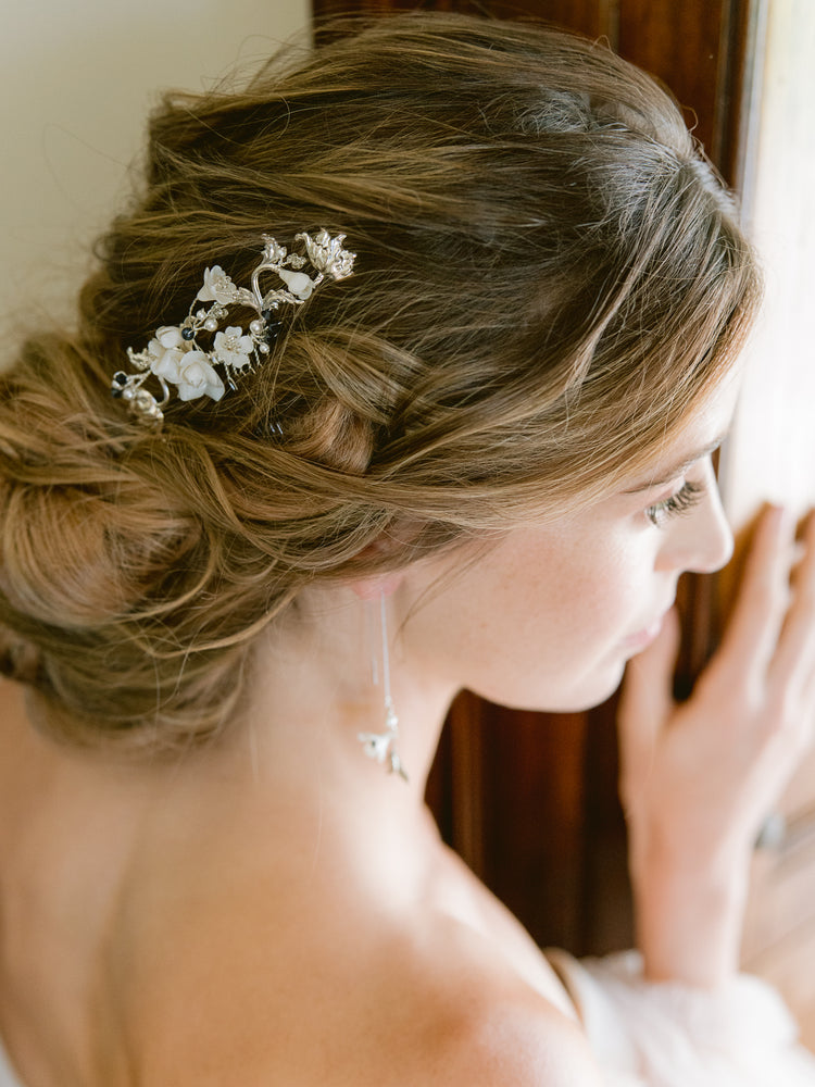 Bride wearing updo with silver bridal hair comb with roses, flowers, and blue pearls and crystals as something blue